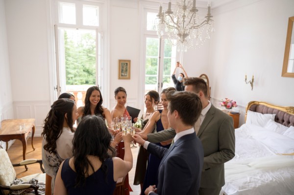 Group shot of friends and family cheers before the wedding